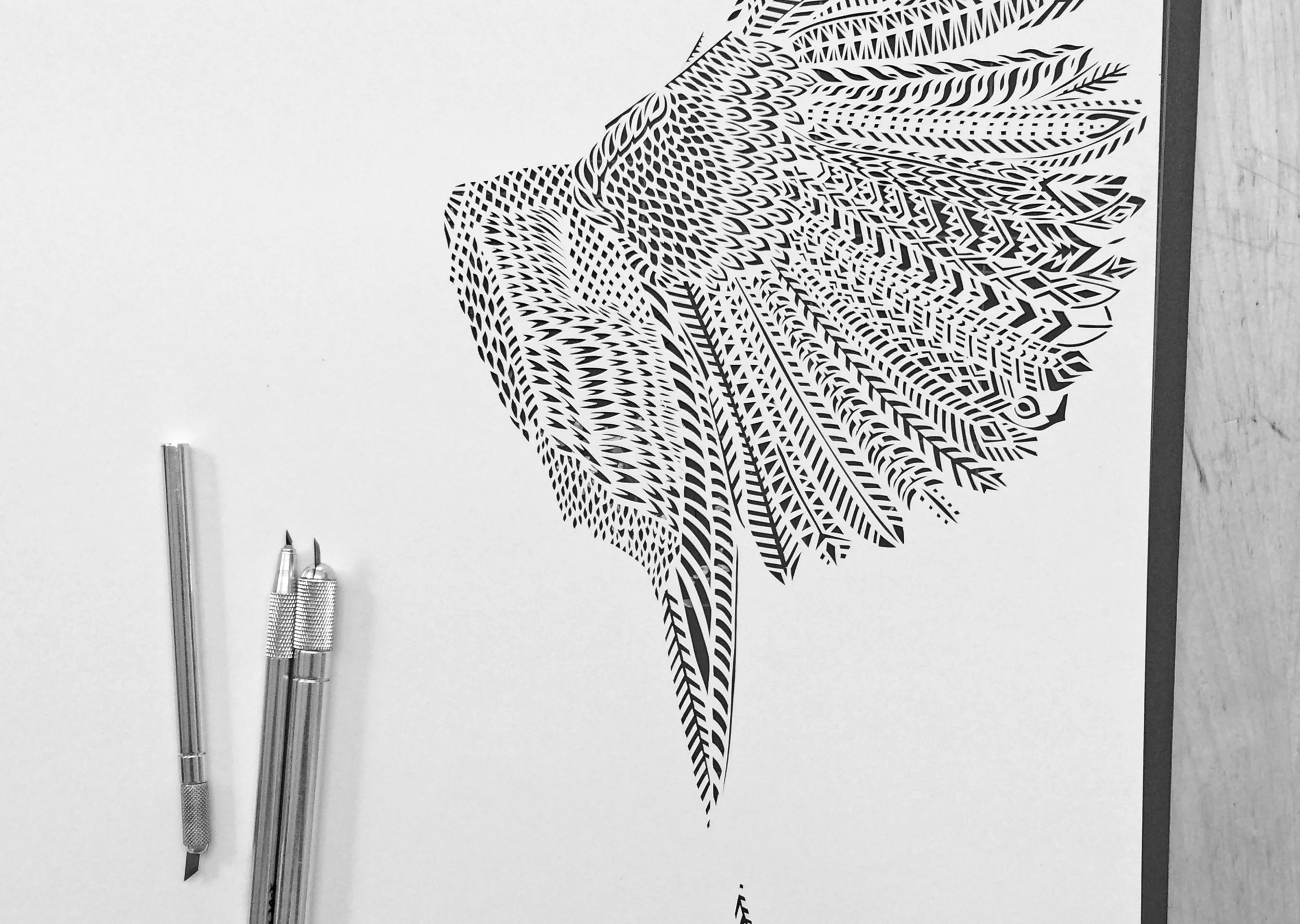 Papercut in progress of a cardinal bird by Thysart