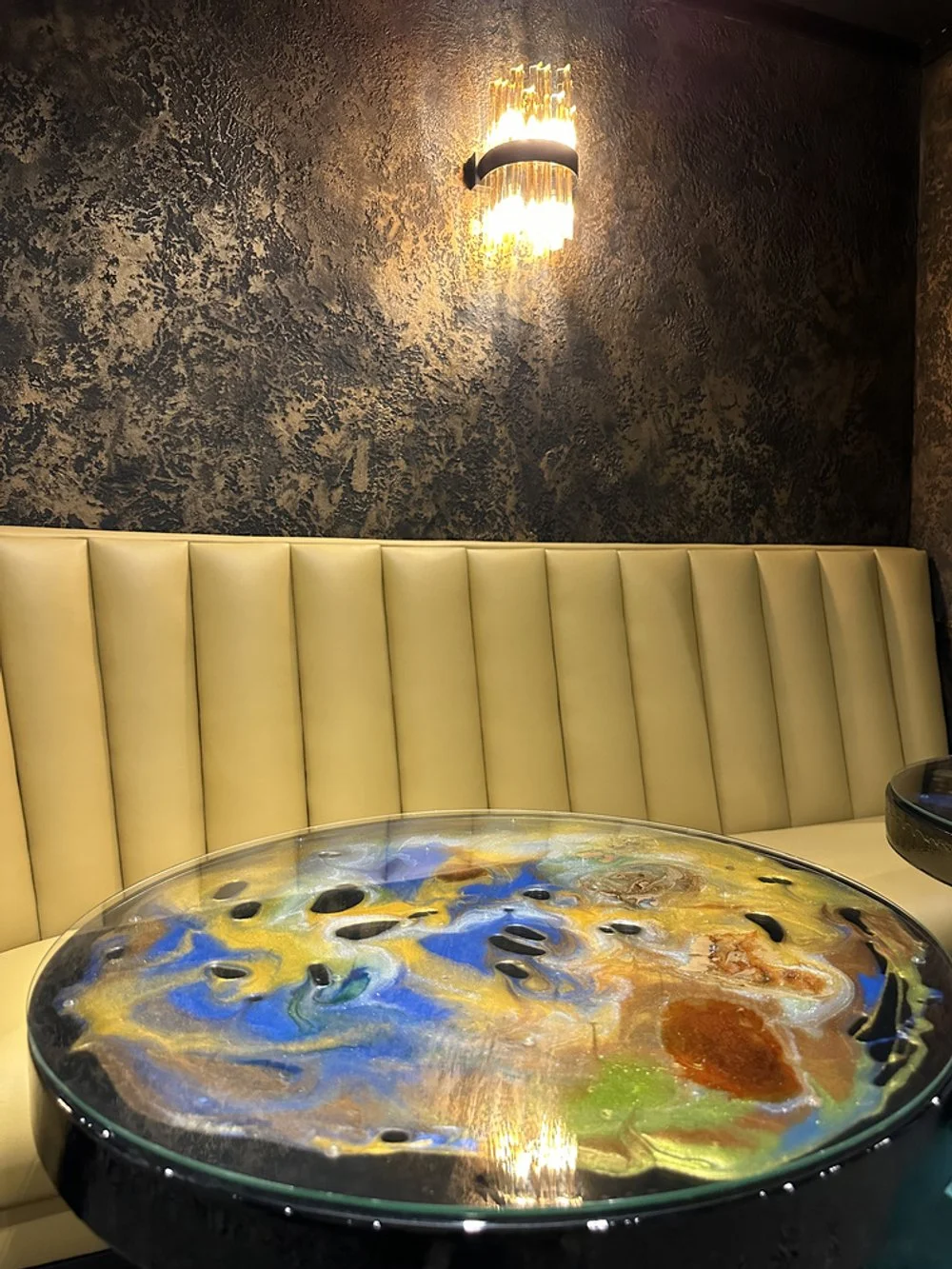 x hand and hand bar black travertino walls bronze bespike epoxy table2.jpeg