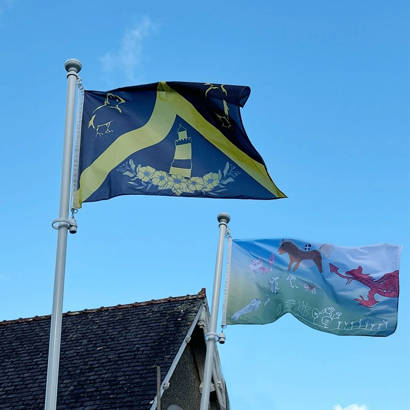 Flags Flying in Llangoed - the FLAGS :) post 3/4 @llangoedvillagehall once again has a flagpole, with flags to represent our community and celebrate special events. 

The next two flags come from Rhodri Roberts and the students of Ysgol Llangoed. The