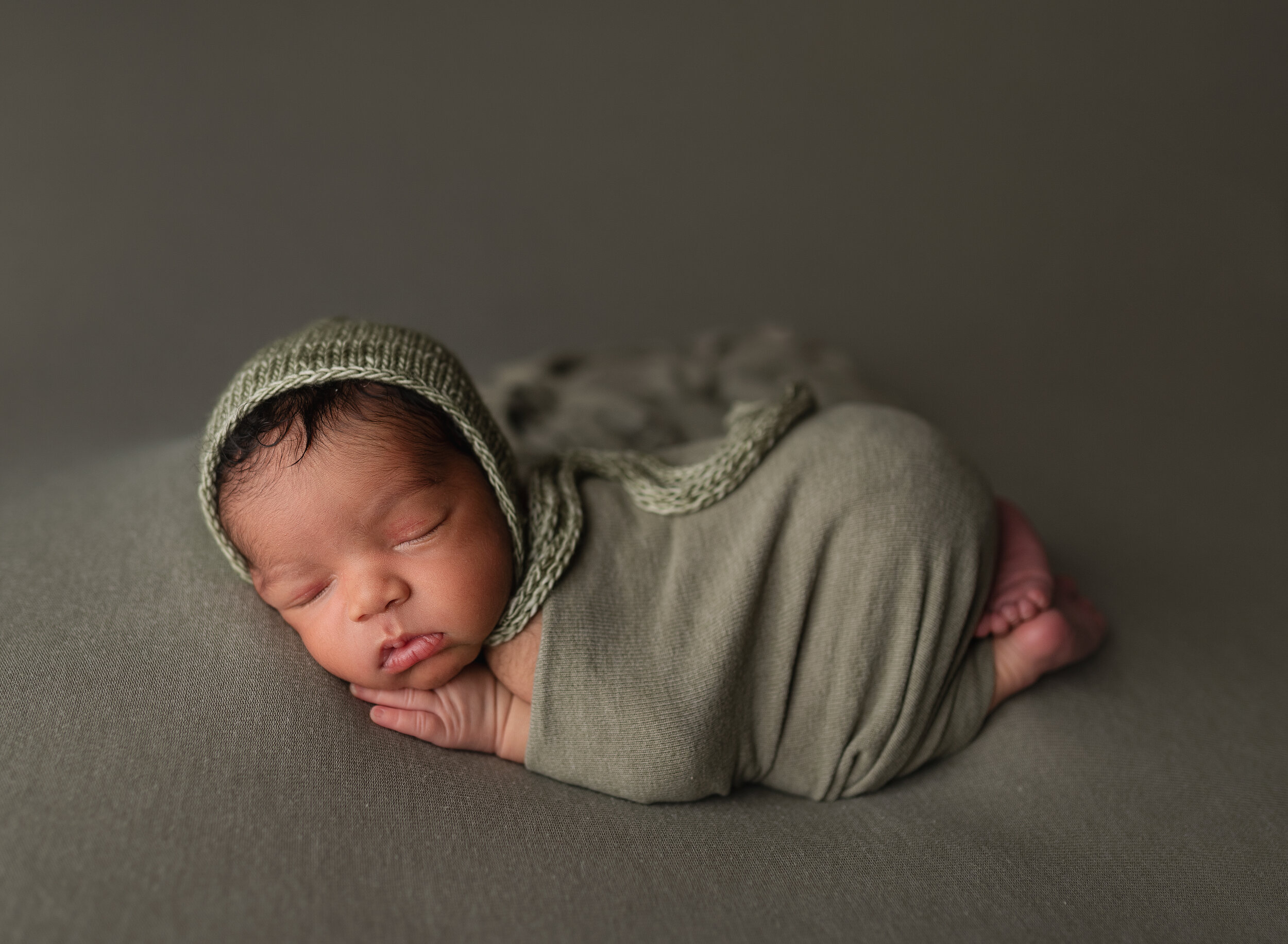 Morgan City Newborn Photographer baby boy green bonnet sleeping