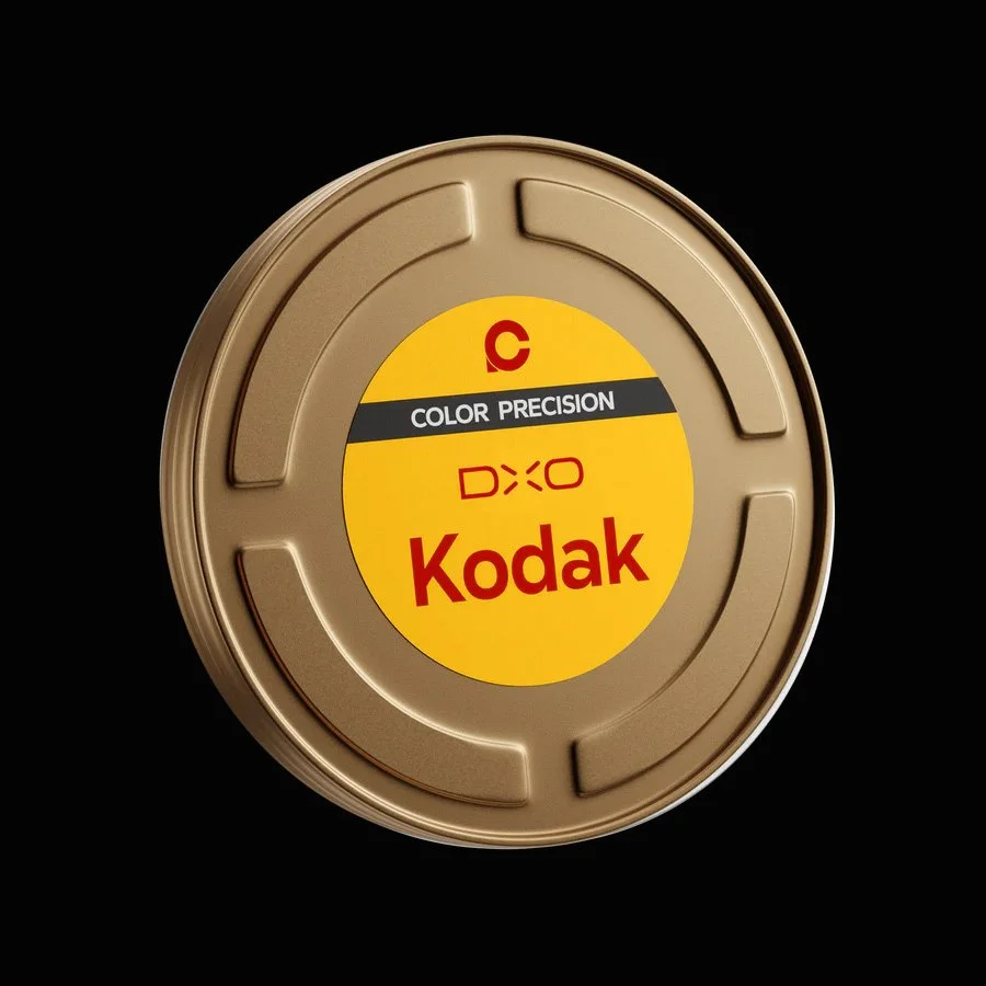 Kodak color film canister with a yellow label, black and red text, on a black background.