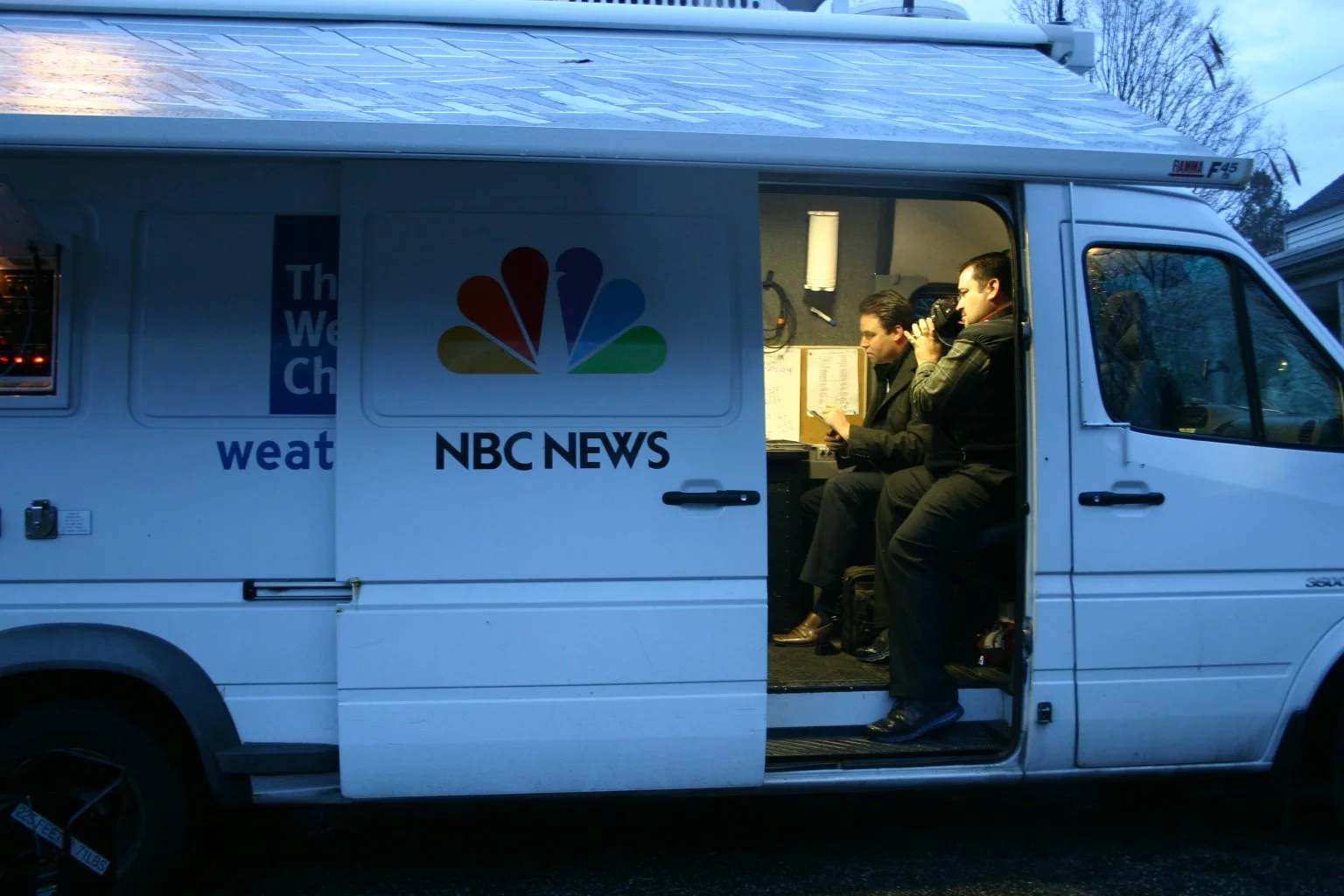 Anthony Quintano capturing behind the scenes content inside an NBC News van with Jeff Rossen an NBC News correspondent.