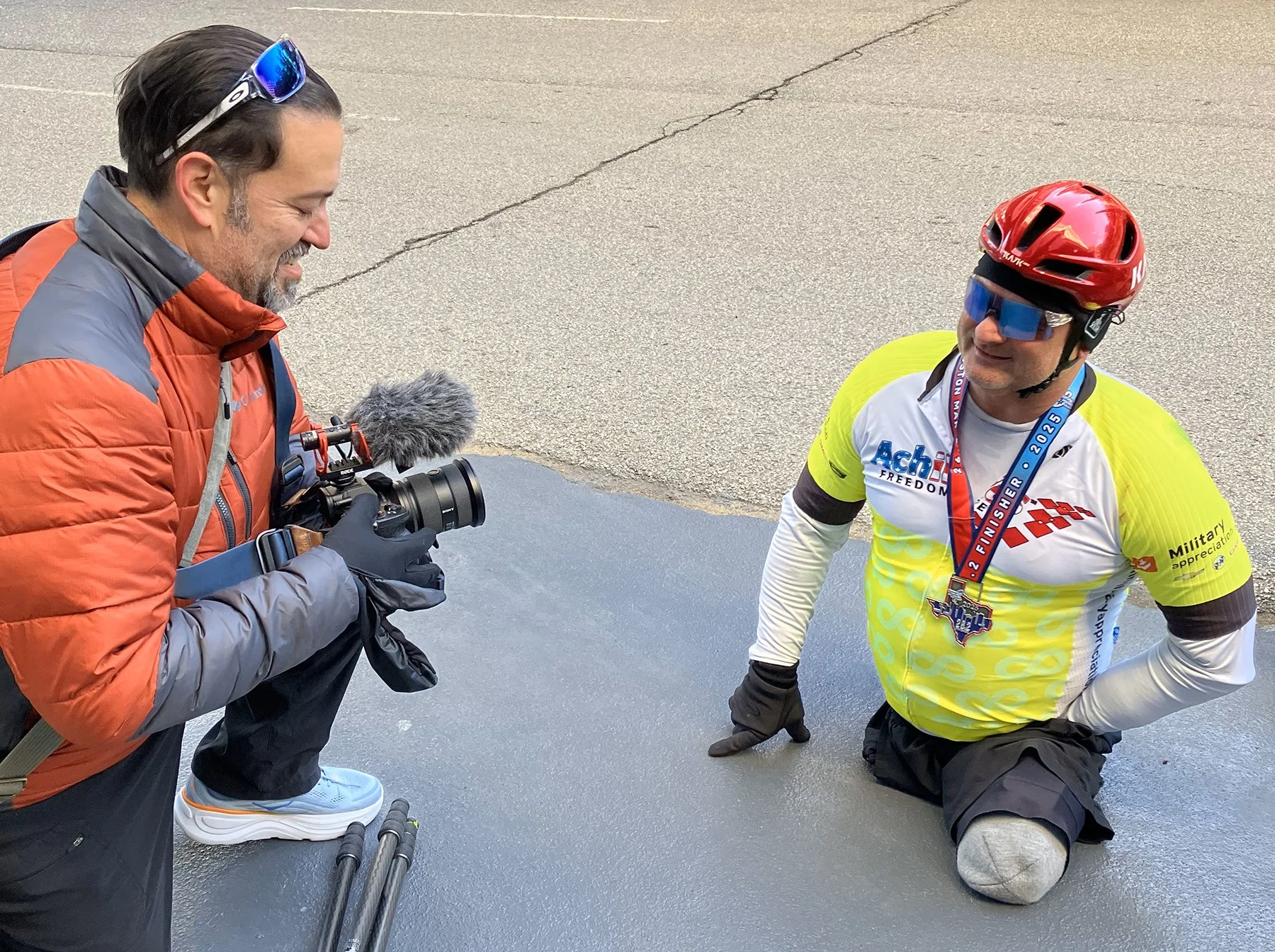 anthony quintano filming disabled athlete achilles houston marathon 2025.jpg