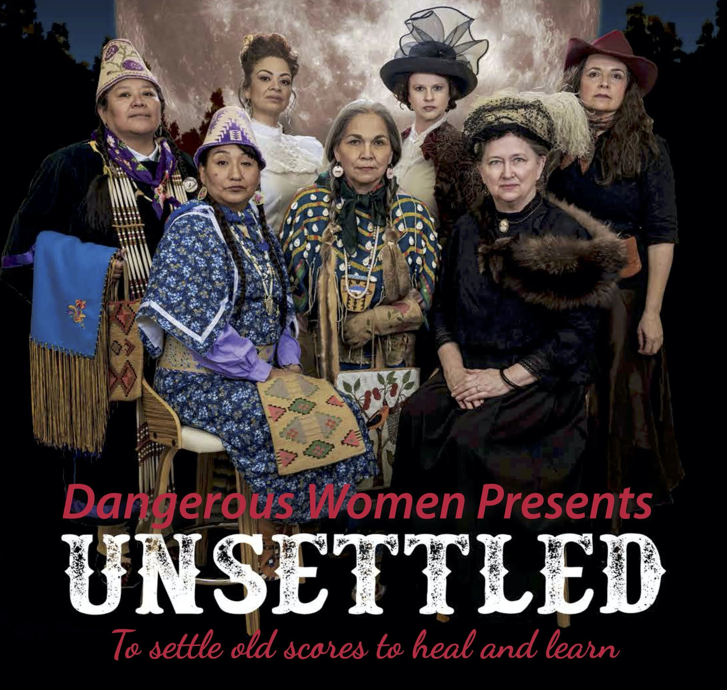 A group of women dressed in historical costumes, standing outdoors with a background of trees and a cloudy sky. They are wearing various old-fashioned dresses and hats, with some accessories like necklaces and jewelry.