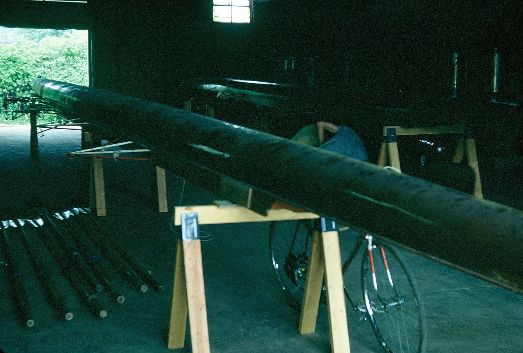 The club’s first set of equipment on sawhorses in the warehouse — boats purchased from Windsor Boat Club, oars from Michigan State University. June 1976.