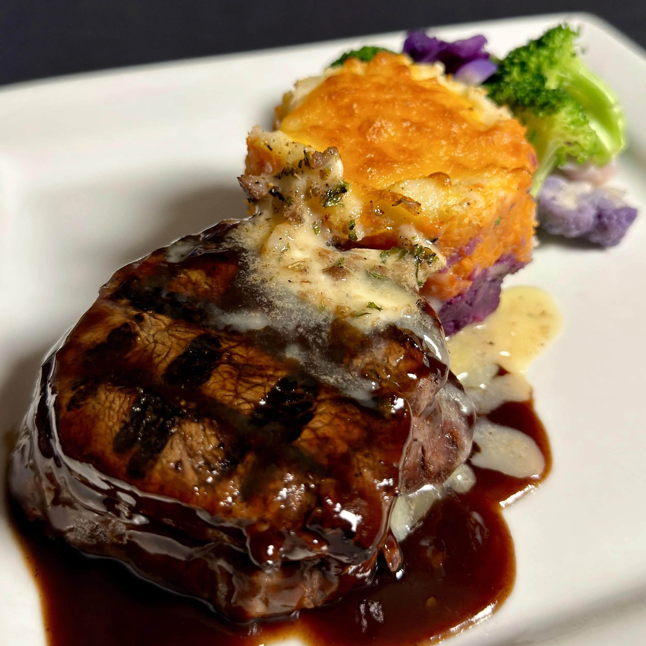 Black Bear Bistro's award winning Filet Mignon with sweet potato gratin, lingonberry demi-glace, bone marrow butter, and seasonal vegetables.
