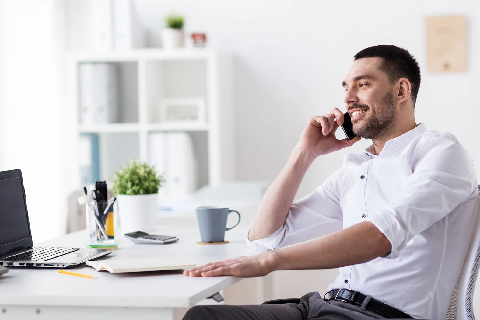 businessman-calling-on-smartphone-at-office-PPD6Q4G.jpg