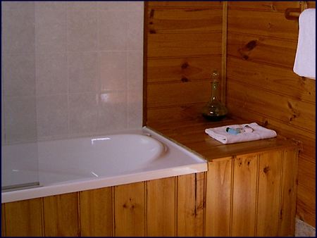  The private ensuite bathroom features a full bath with shower. Self contained bush cabin accommodation at Cradle Mountain Highlanders Cottages in Tasmania Australia with the comforts of home. 