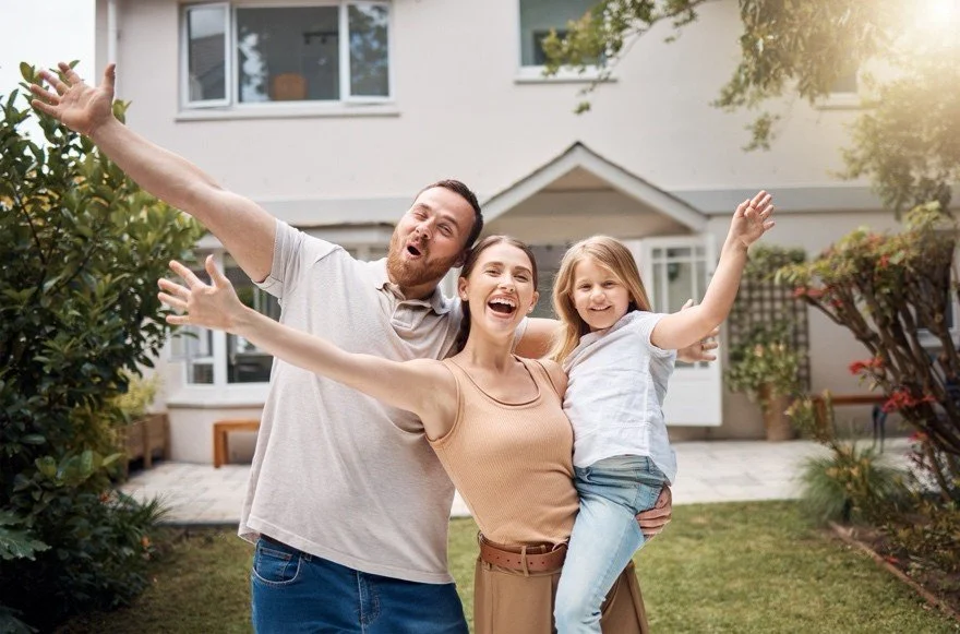 Family in front of new home
