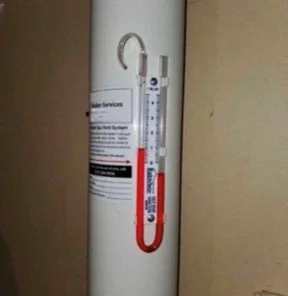 Manometer on an active radon mitigation system.