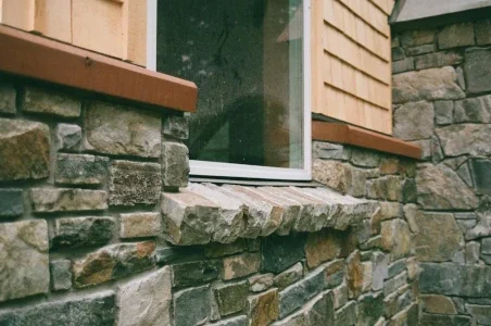 Exterior of window showing a stone sill and exterior facing