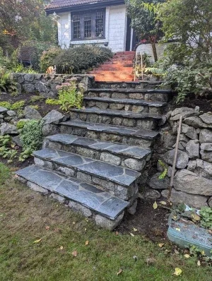 Stone stairs with flagstone steps leading up to a house