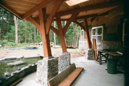 Stone Pillars at the base of wooden timbers supporting a roof