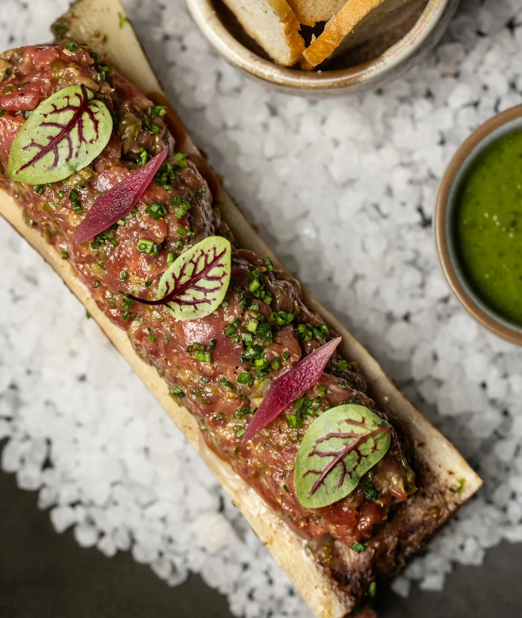 Calling all tartare lovers. Have you tried our latest version yet?

Beef tartare, roasted bone marrow, pickled shallots, salsa verde and toasted baguette.

A rich, indulgent dish made for sharing (or not).

Book a table via the link in our bio.

Open
