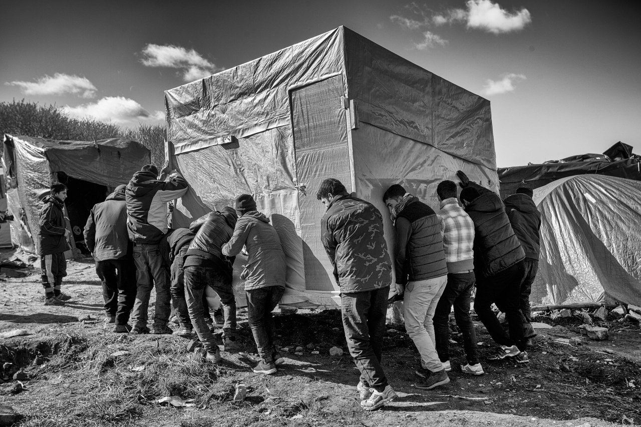  A group of refugees move a shanty in the Jungle of Calais  during a demolishing with bulldozers by the french government, Calais, France, March 4, 2016. In the next days will be demolished Eritrean church &amp; tents of 1K transmigrants.  