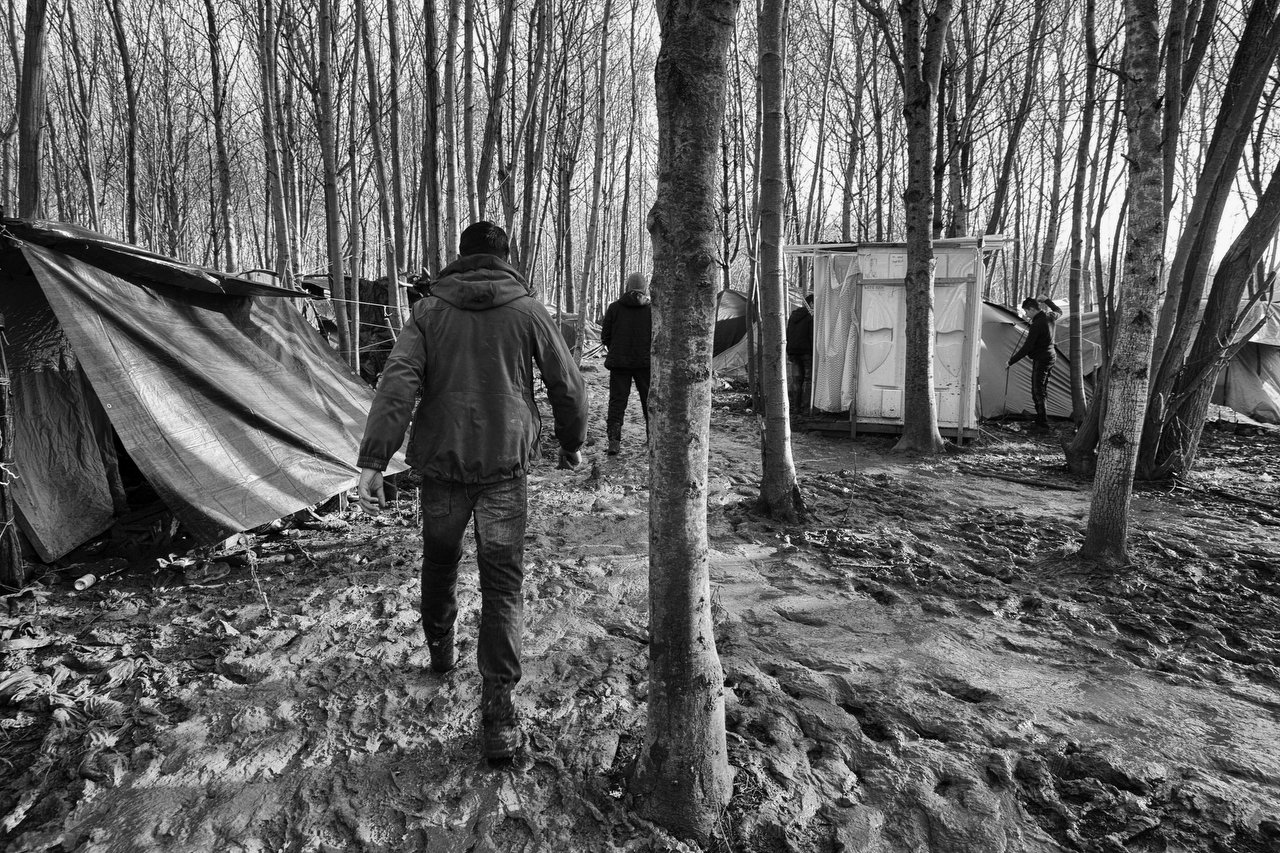  A asylum seeker walks in the mud at the refugee camp of Grande-Synthe, Dunkirki, France, January 8, 2016. Photo Delmi Alvarez. 