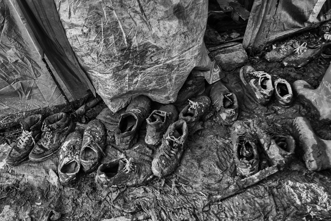  Shoes at the entry of a camp tent of Kurdish migrants Scenes at the makeshift refugee camp of Grande-Synthe, Dunkirque, France, January 15, 2016. Photo Delmi Alvarez. 