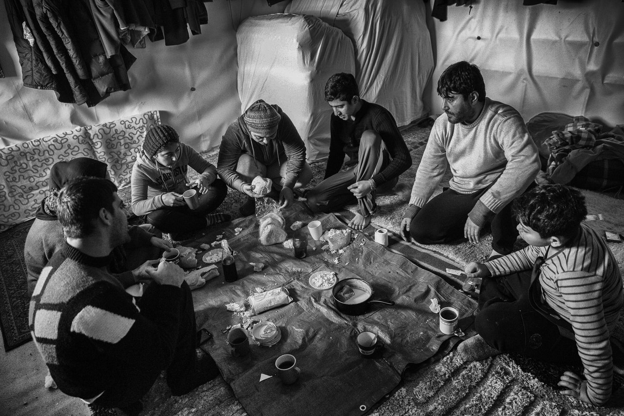  A Kurdish family inside a tent at the makeshift camp of Grande-Synthe, Dunkirque, France, January 15, 2016. Photo Delmi Alvarez. 