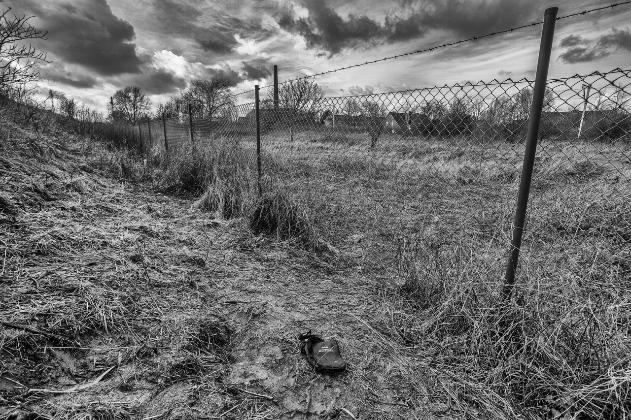  Hole in the fence in the former sugar factory, from where transmigrants cross to hide in the lorries parked in the gas stations, in Veurne, Belgium, February 9, 2016. Credit Photo Delmi Alvarez. 