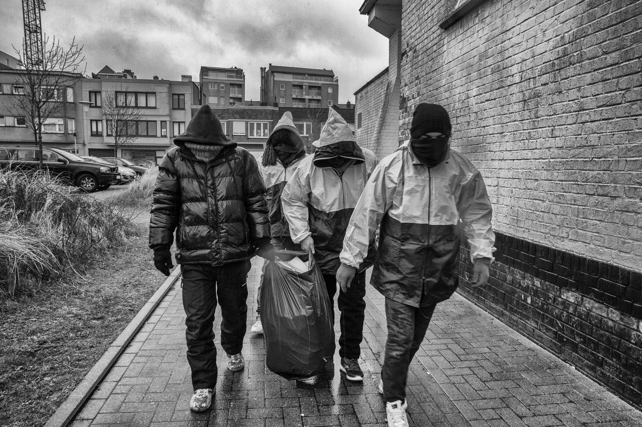  A group of transmigrants clean the church area in Zeebrugge, Belgium, February 9, 2016. The priest of the church Fernand Marechal help them with food and sleep inside when the temperatures are extremely below. The transmigrants sleep outside the chu