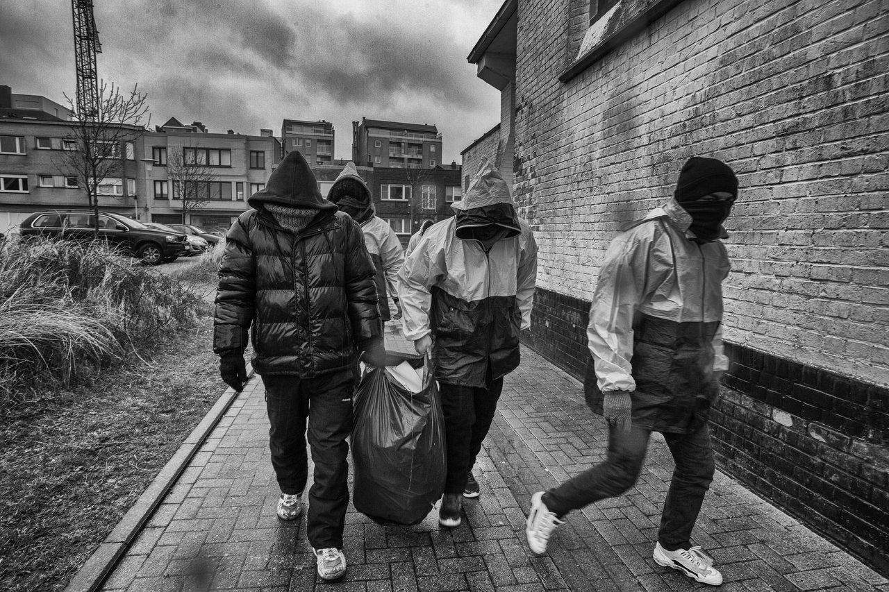  A group of transmigrants clean the church area in Zeebrugge, Belgium, February 9, 2016. The priest of the church Fernand Marechal help them with food and sleep inside when the temperatures are extremely below. The transmigrants sleep outside the chu