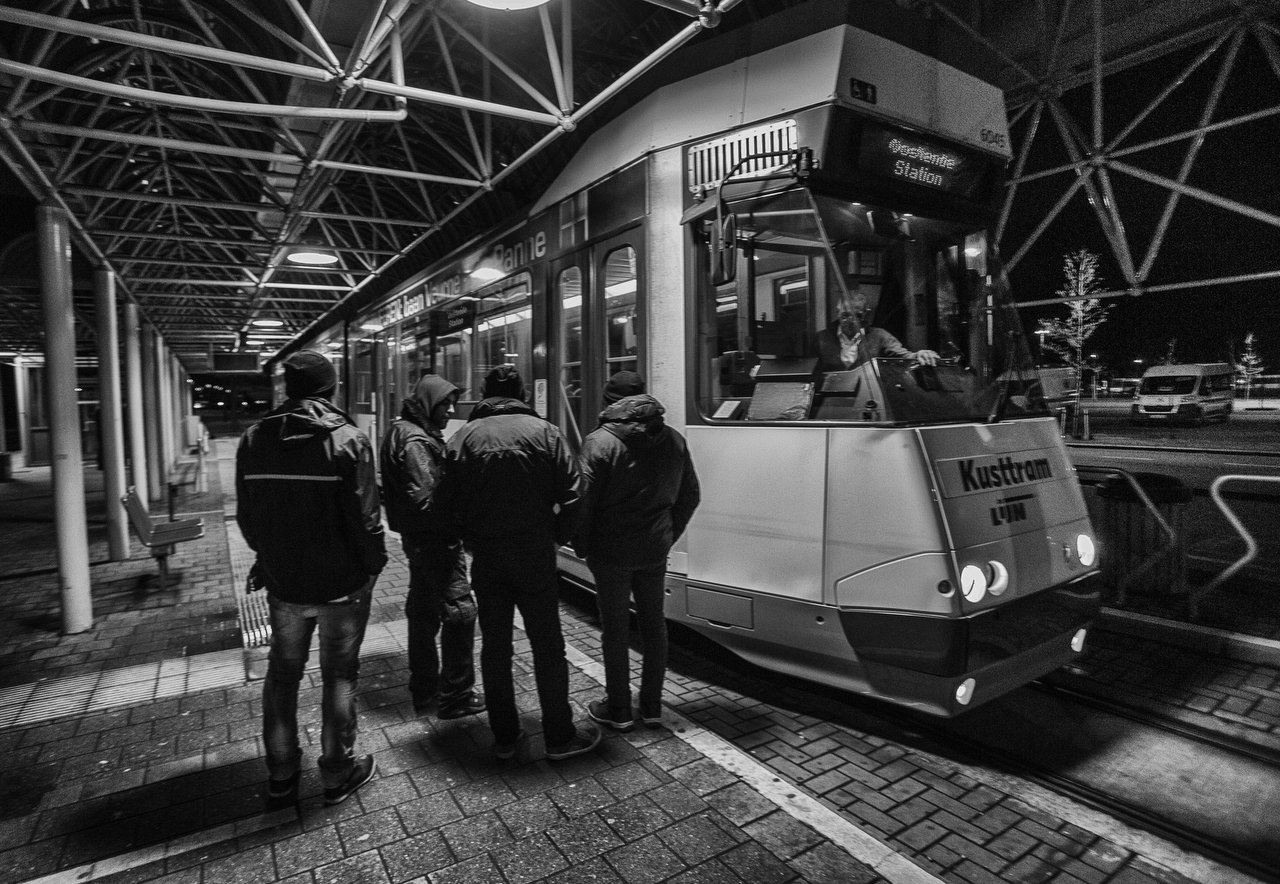  Four transmigrants from Shiraz, Iran, are outside of the tram after be banned by police in Adinkerke, Belgium, February 9, 2016. Credit Photo Delmi Alvarez. 