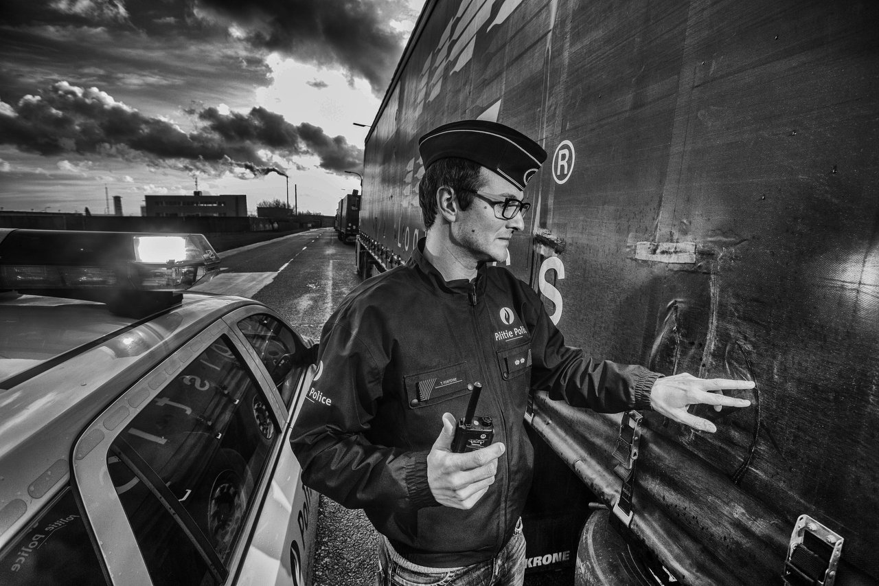  Local police commissioner and chief operating Toon Fonteyne in Veurne, Belgium observes the slashes on the canvas of a truck parked in Veurne. Transmigrants made these cuts going to know what kind of merchandise carry and hide inside, in Veurne, Bel