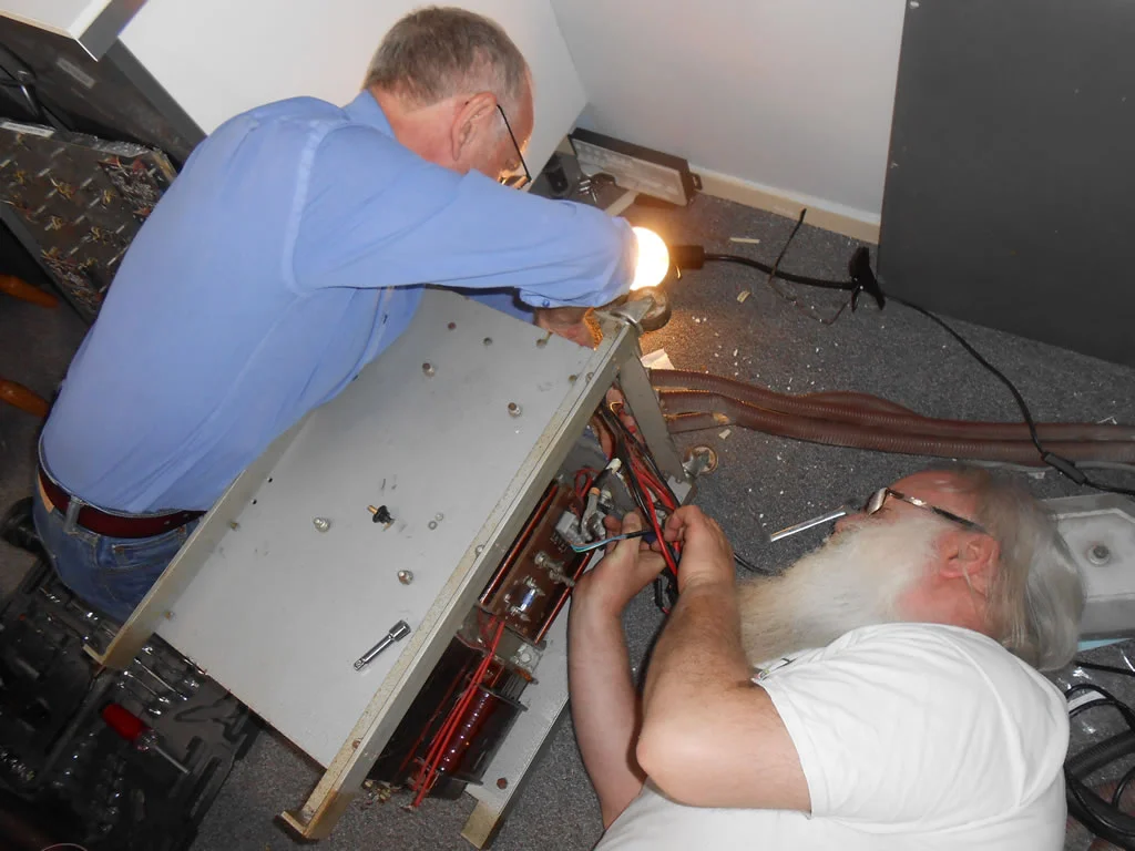 Fig 9 - Phil Hayes (Colossus engineer) and Peter Onion (803 engineer) working on the hidden nuts and bolts