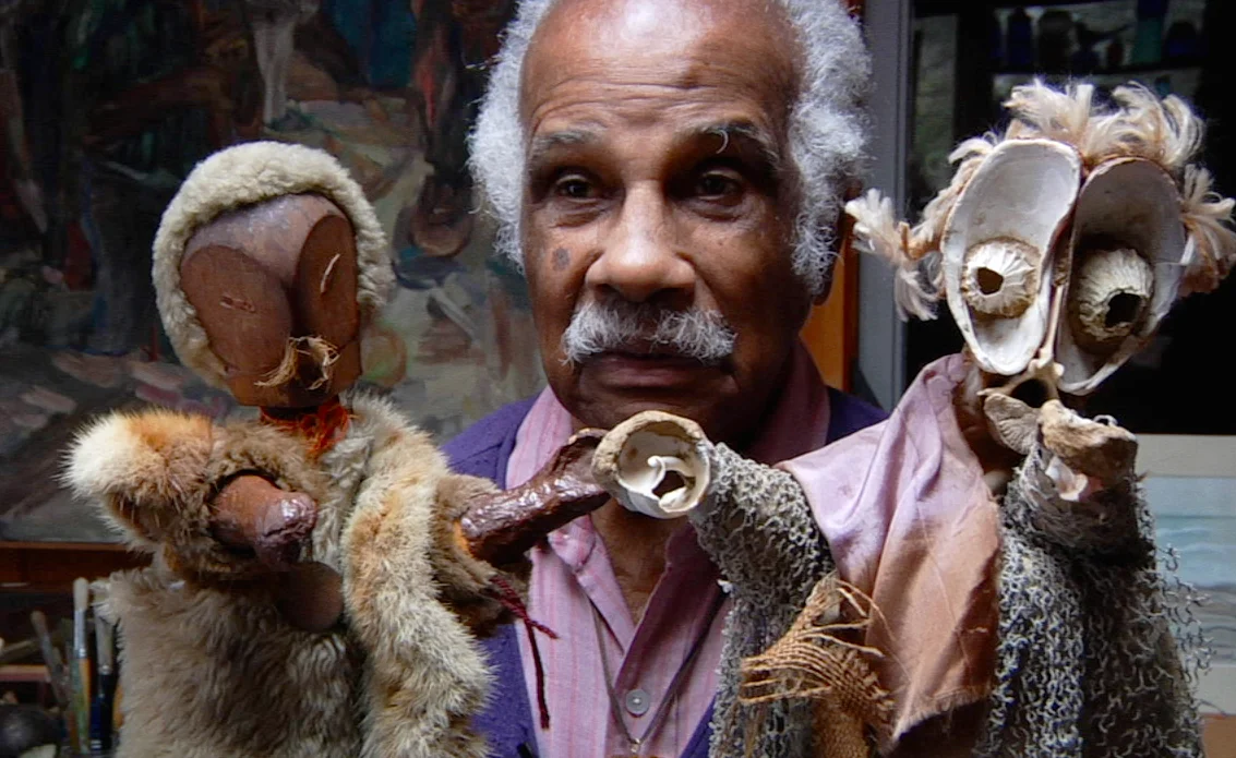 Ashley Bryan with his puppets Babatu and Osaze made from found objects
