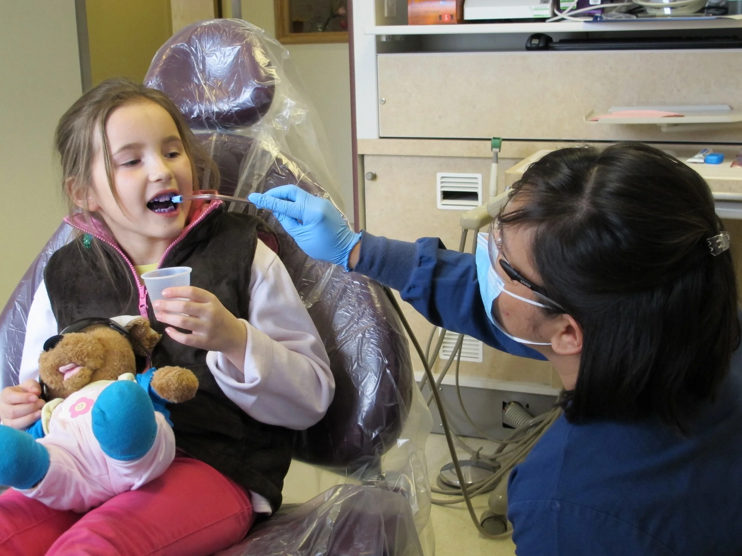 Dental Therapist and child patient wtih teddy.jpg