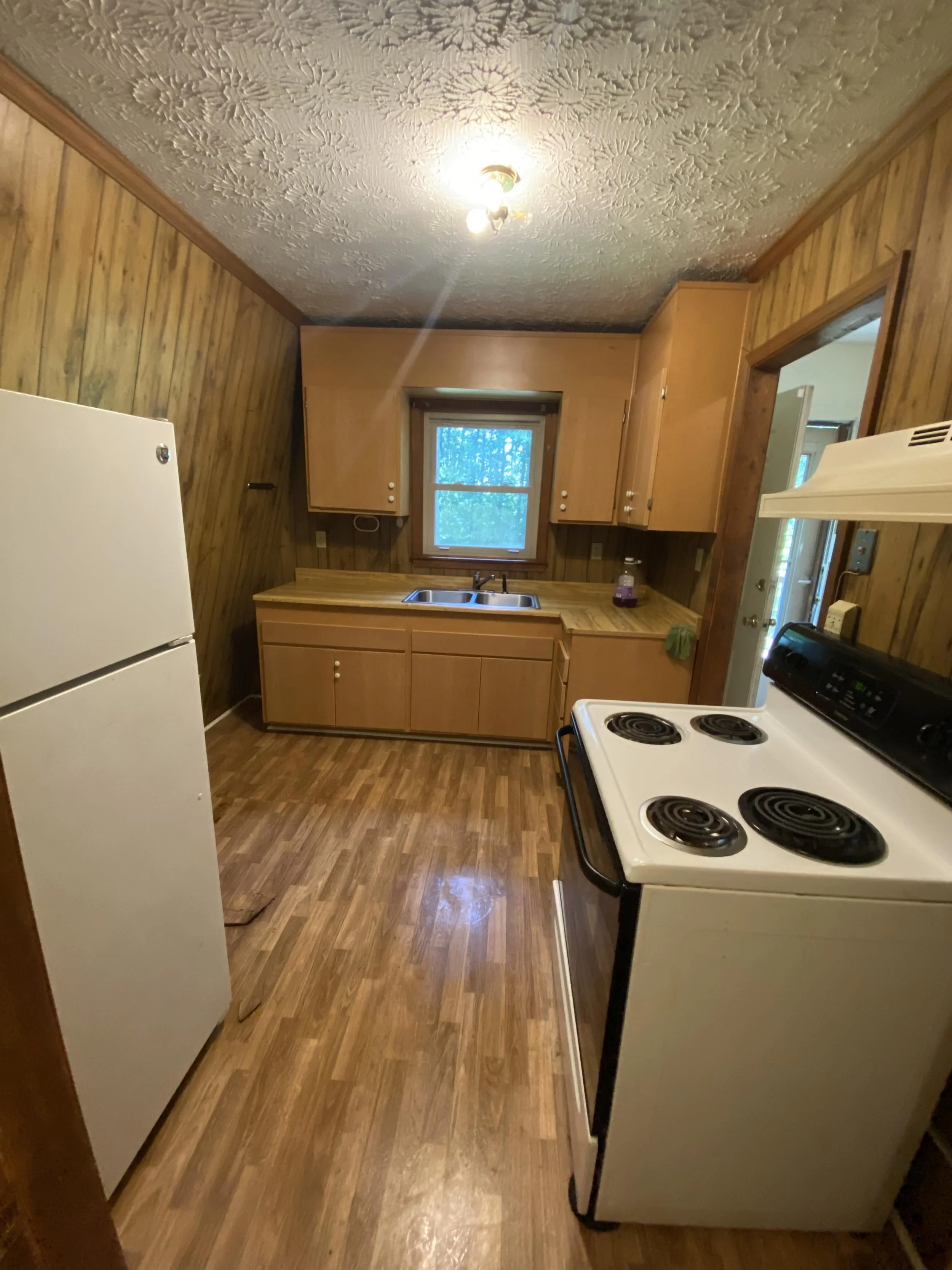 Kitchen in an A-frame house before renovation