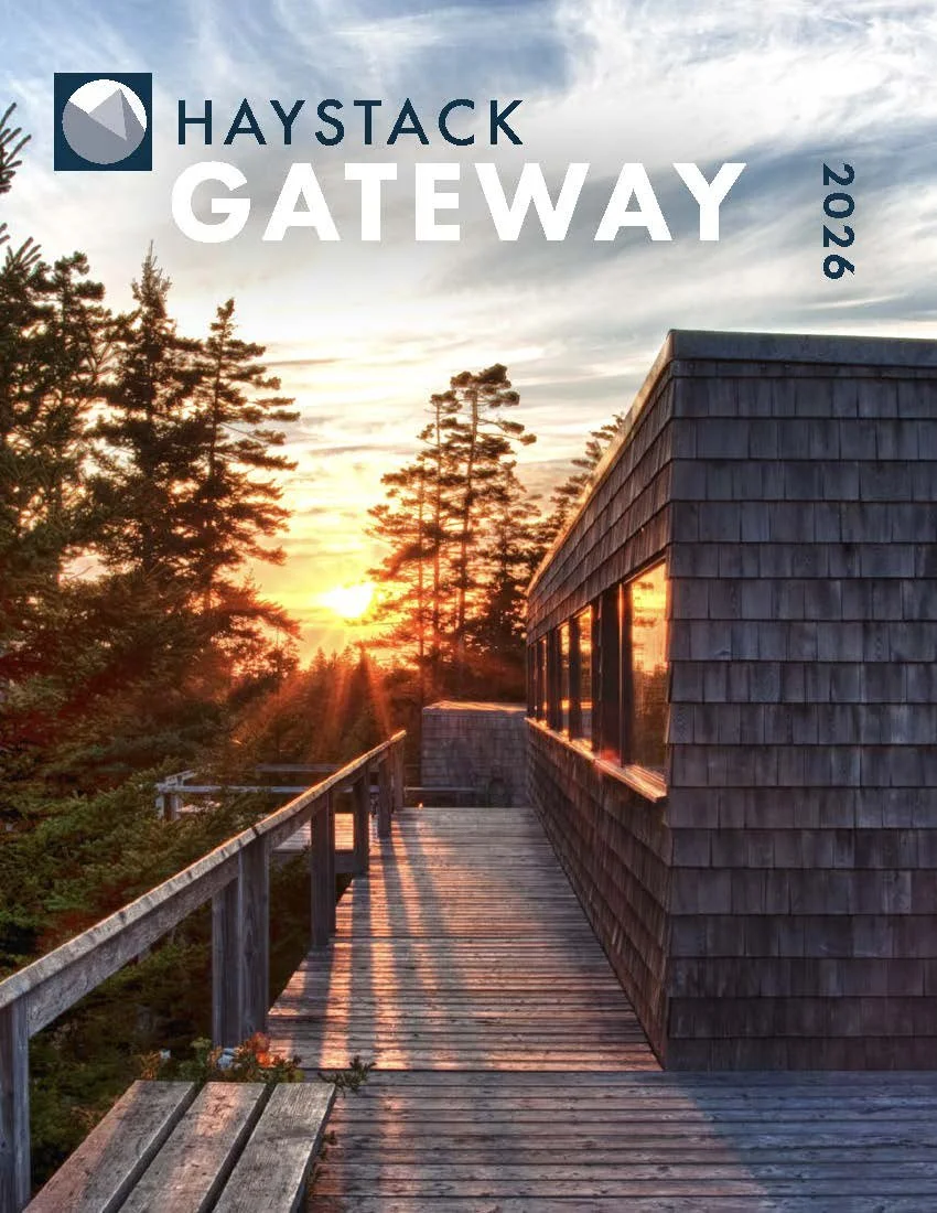 Image on Haystack camps of grey shingled building and deck with spruce trees and orange sunset in background. Haystack Gateway 2026 text overlay.