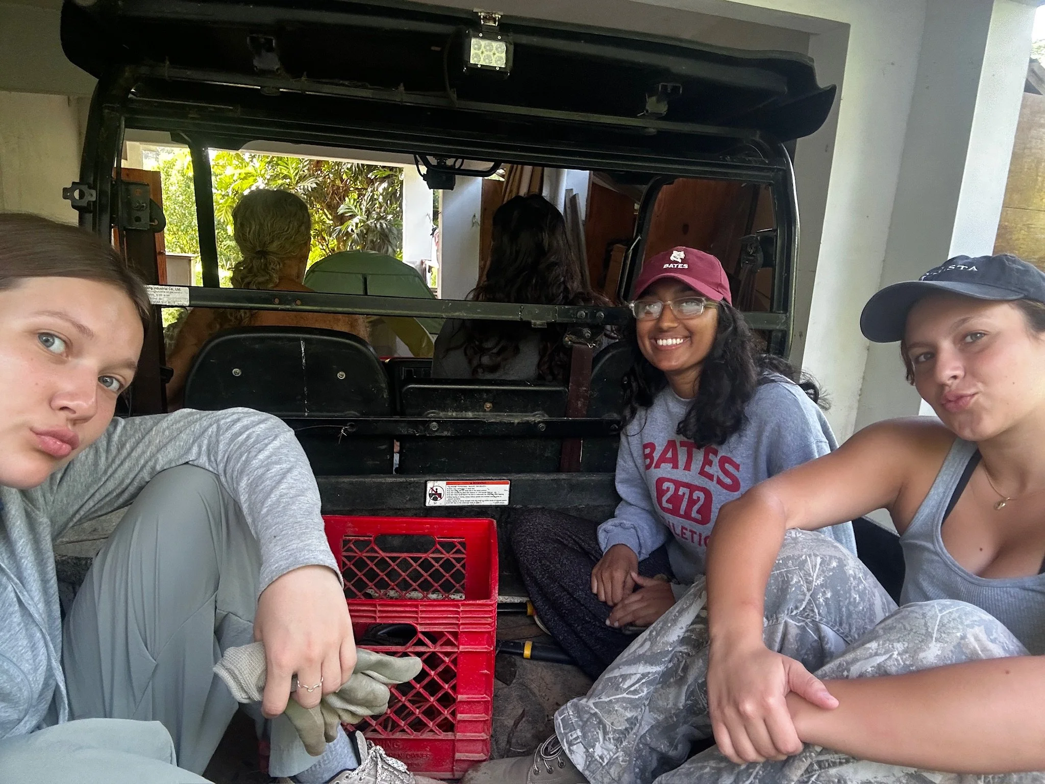  Samantha, to the far right, and two of the volunteers at Buena Fruta Farm sitting in the bed of the pick up truck to travel the bounds of the farm. 