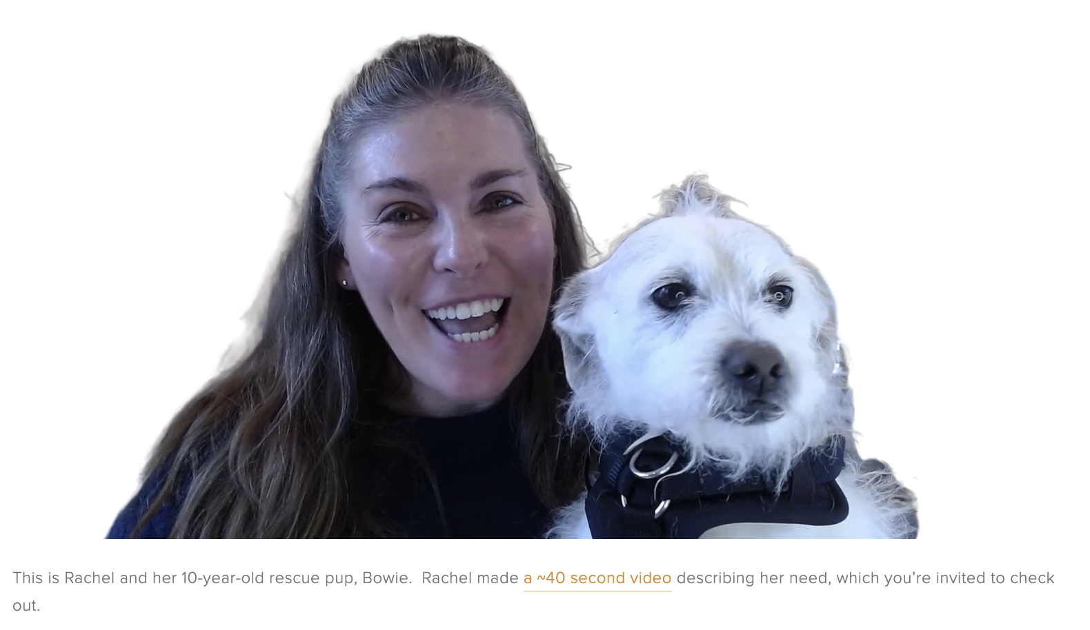 Rachel is smiling, holding her terrier, Bowie.