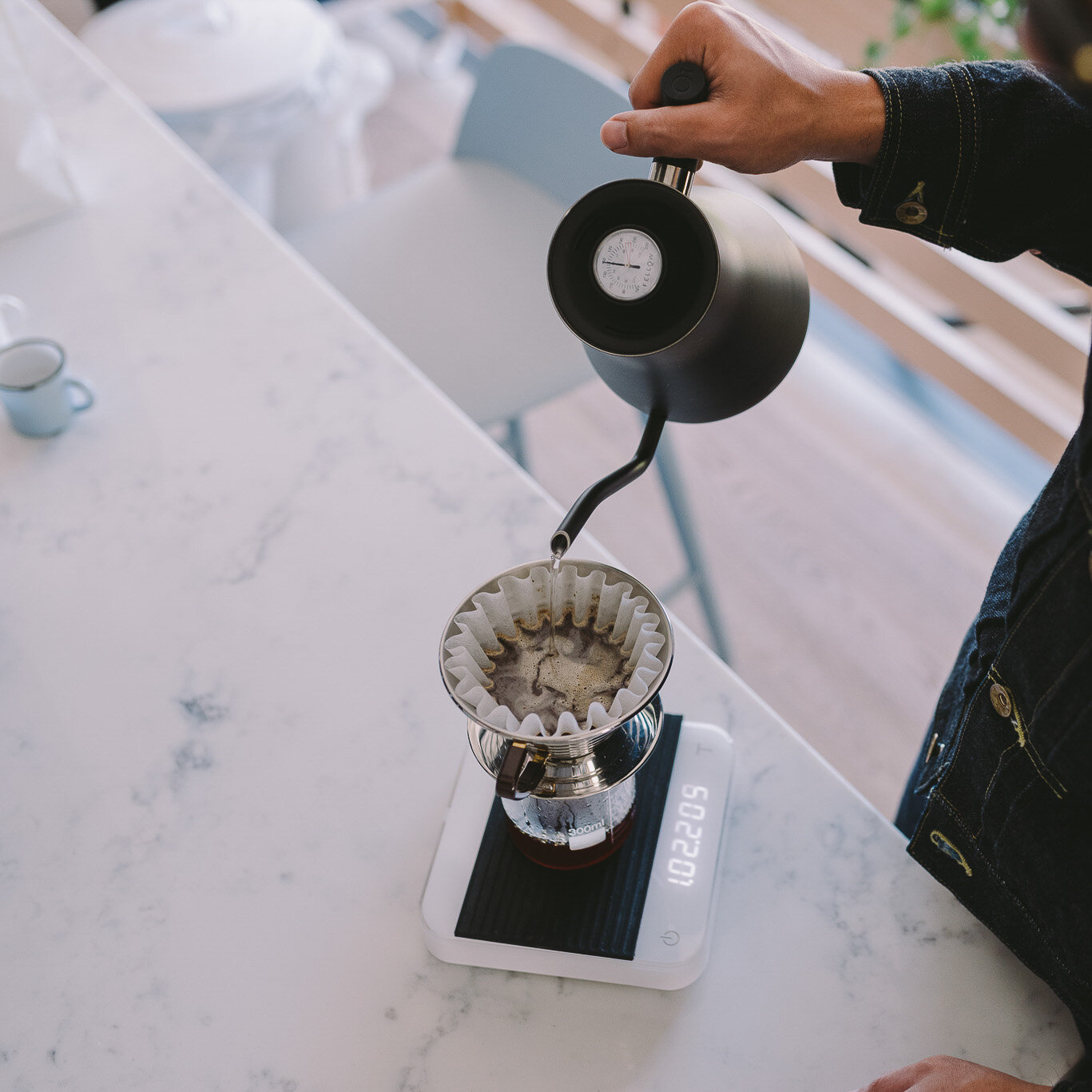 Adding coffee to V60 2 cup.