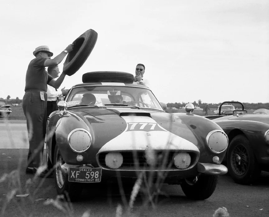 Back in the day they drove the Ferrari to the races, here unloading spare tires from the top of the car.