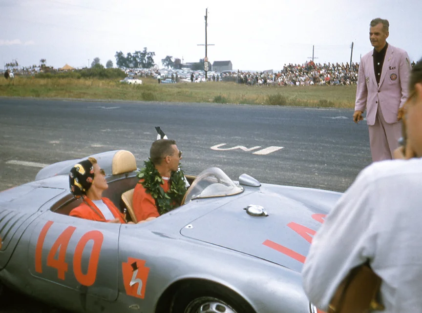 Bob Holbert and wife get congratulations from starter Tex Hopkins in his very famous lavender suit. Holbert won the Queen Catherine and then doubled it up with 2nd overall in the Grand Prix,.