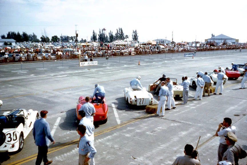 The drivers have crossed the track and are leaping into their cars. Many would simply forget seat belts to save time. A silly move for a 12 hour race.