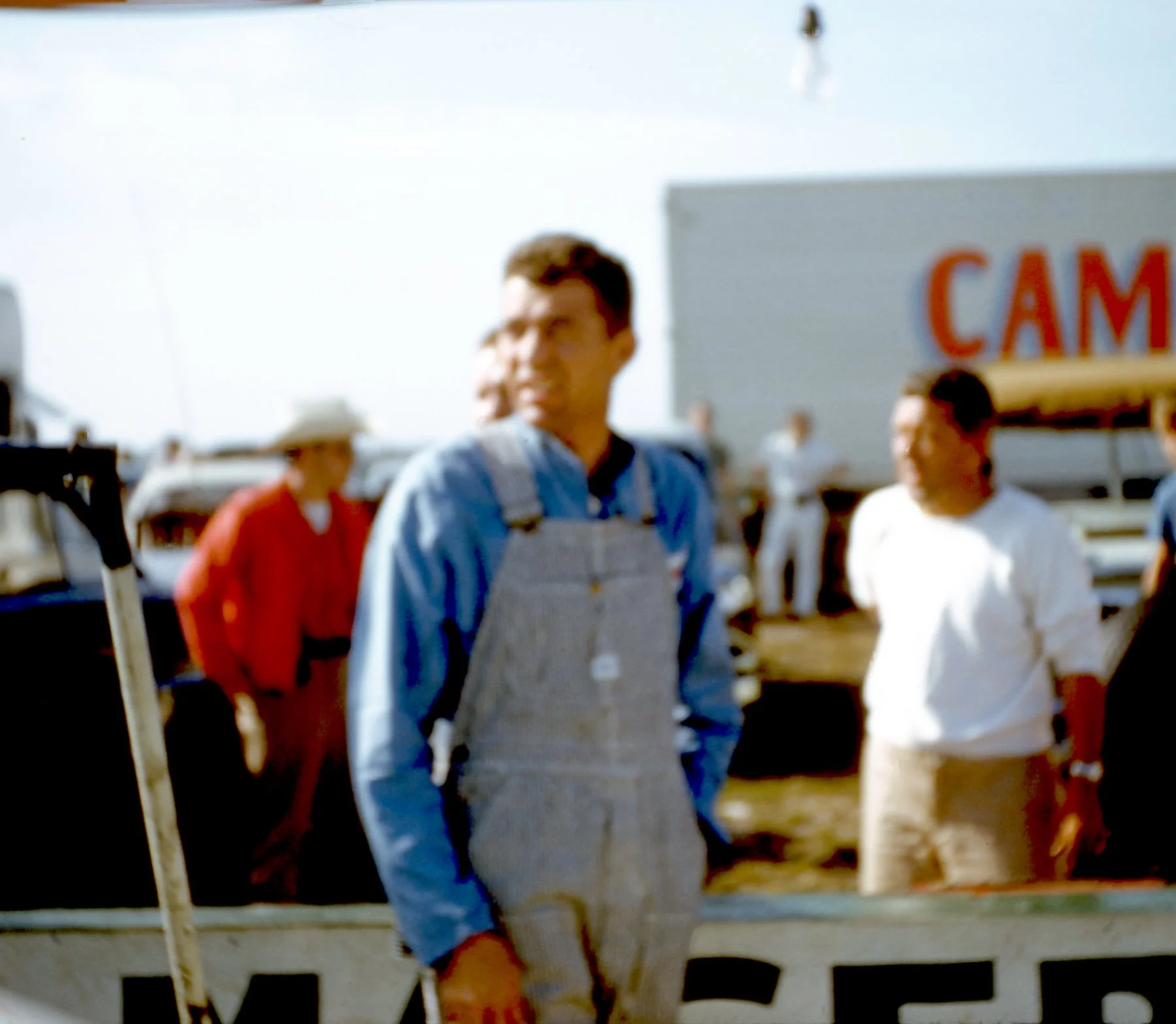 Carroll Shelby in his chicken farmer coveralls had an unevenfrul weekend driving with Masten Gregory in a Camoradi Maserati. The car lasted 3 laps.