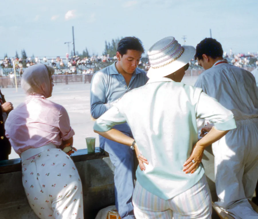 Pedro sits on the pit wall, his Mom in the polka dot slacks attended the brothers races religiously.