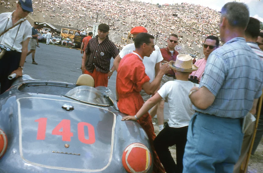 Bob Holbert leans against his Porsche 550RS. Note the huge crowd that came to the Cumberland airport to spectate.