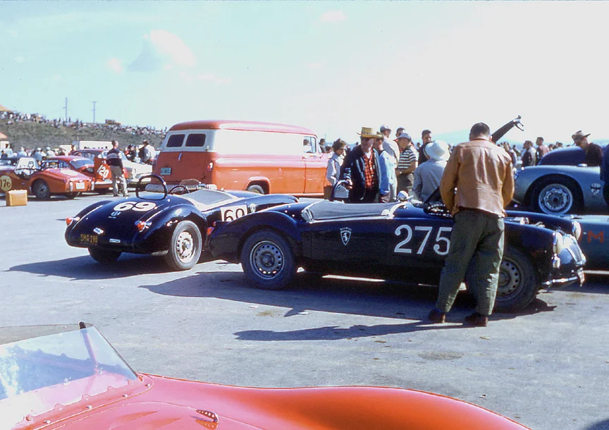 MGA TWIN CAMS: The cars of Ted Rounds (brown jacket) and Hank van Duesen sit in the huge Cumberland paddock. Maserati 200S provides the foreground.