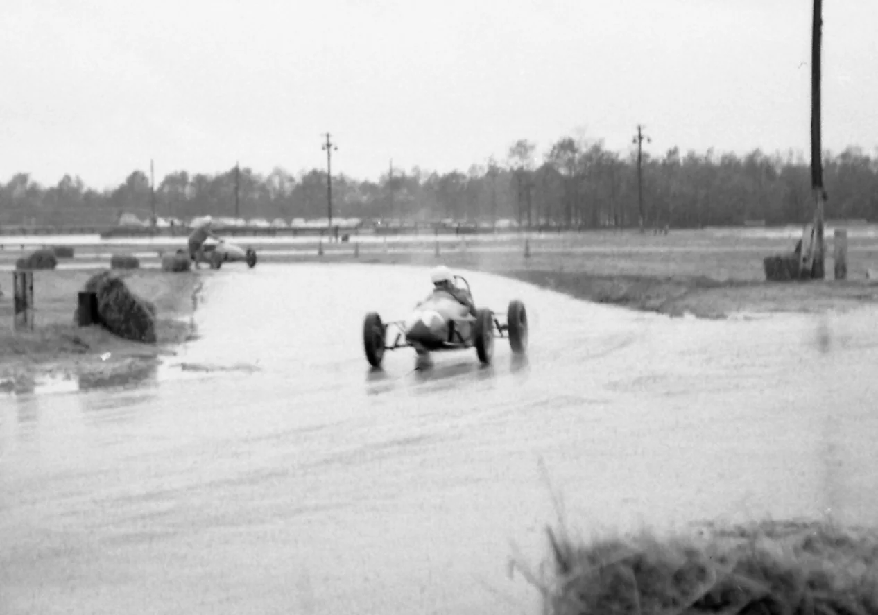 Head down to keep the rain from stinging, an FIII driver (we think Lex duPont) comes off the inside loop and back onto the oval.