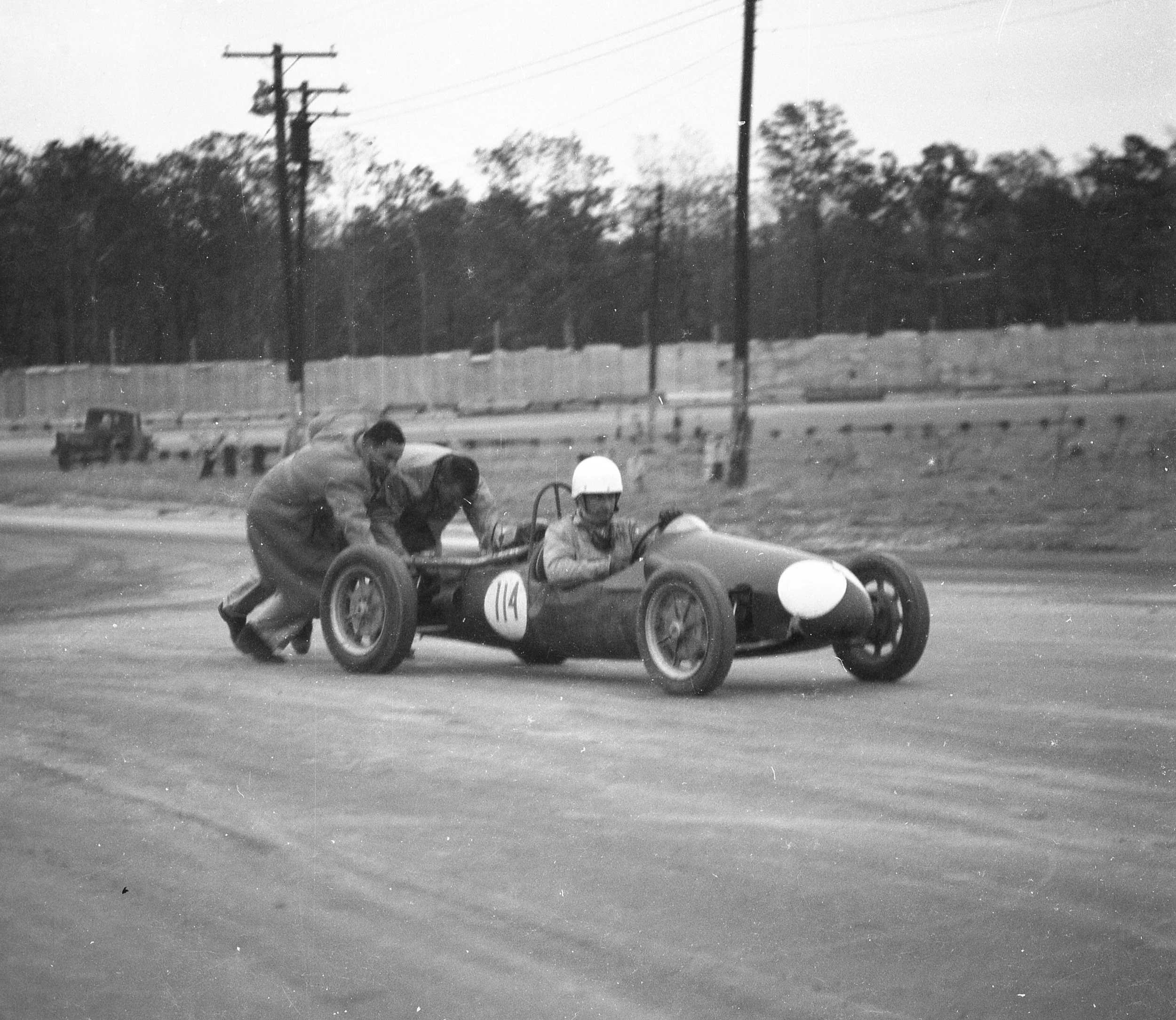 F III cars had no starters. They were motorcycle engines. Here Paul Richards gets a push to start his car.
