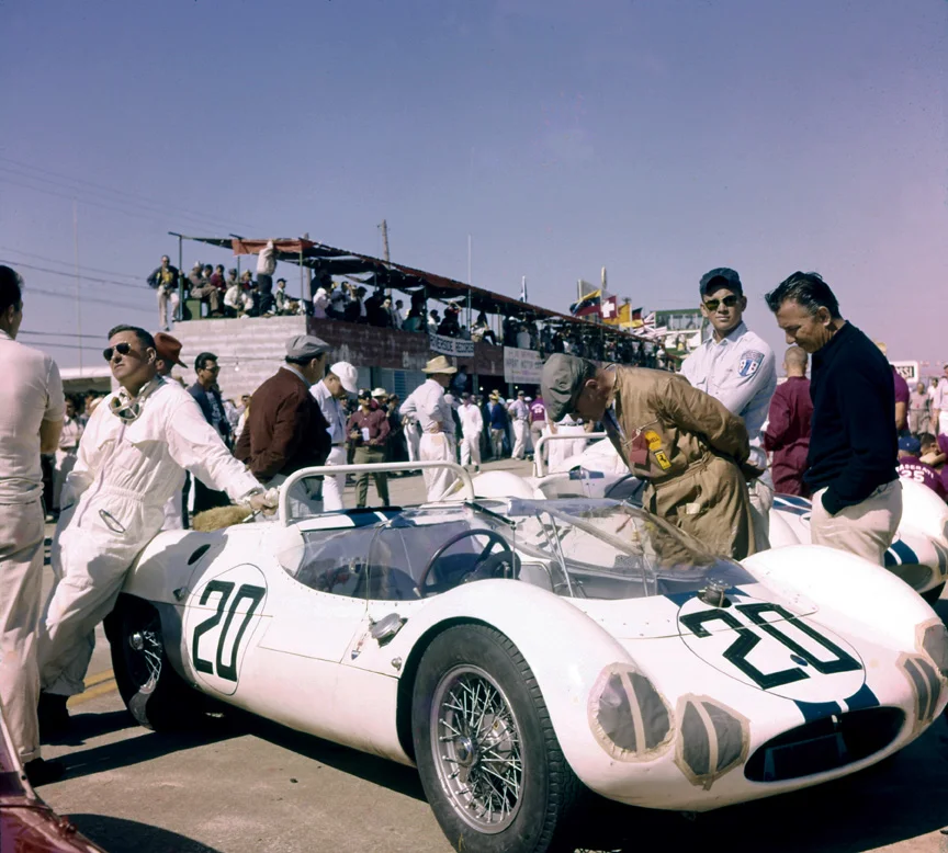Walt Hansgen leans on his Tipo 63 rear engined Maserati birdcage wearing its Cunningham white with blue stripe livery. Walt co drove with Bruce McLaren but the car failed early on.