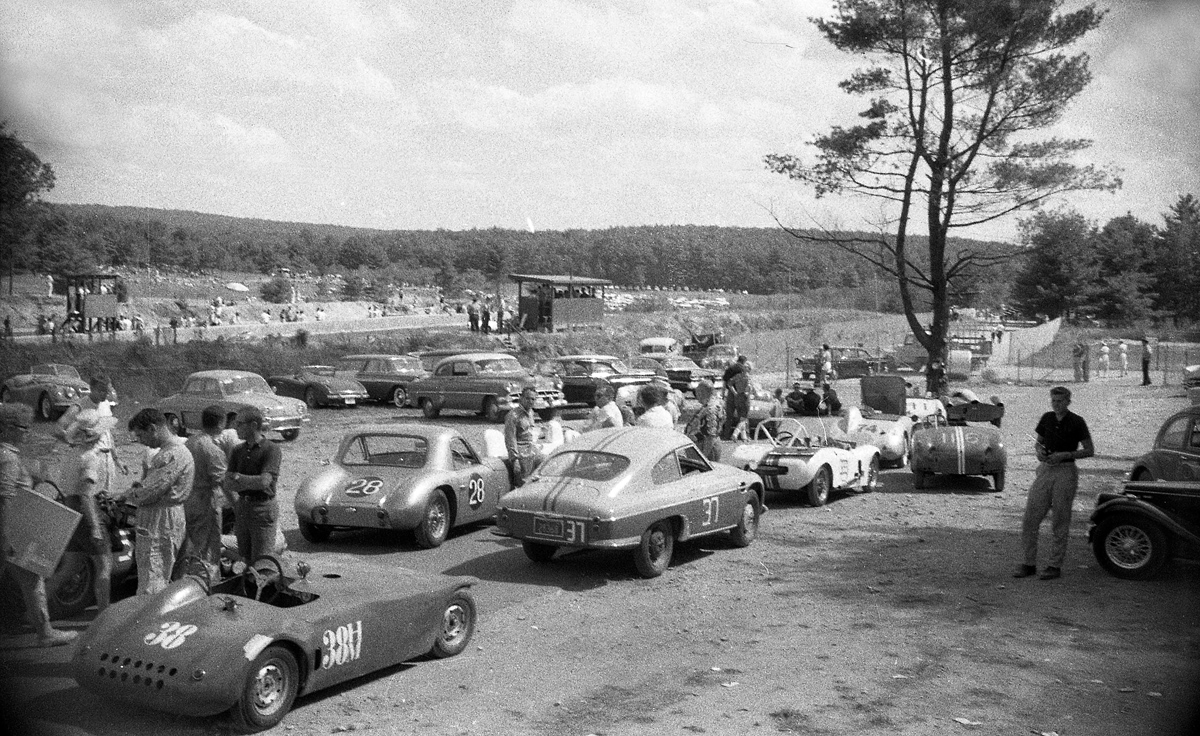 H & G modified and H production cars in the pits. I’m not sure if this is before or after the race. But a great shot of the diversity of cars that raced in those days. #38 Danielini special, #37 DB Panhard, #28 Jomar coupe. Ahead are a Cooper, Candy Poole’s PBX among the crowd.