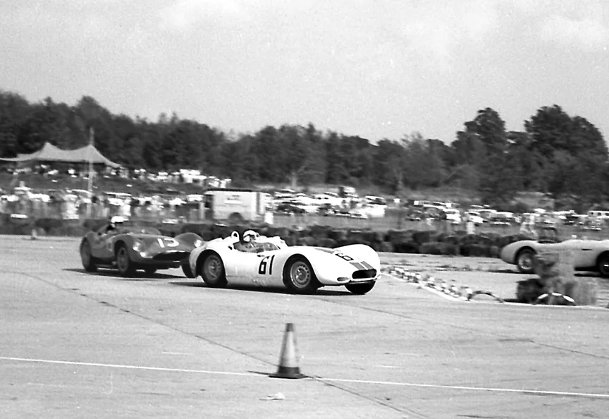 Early on Ed Crawford leads Chuck Daigh. Note the Jag still looks good but Daigh has been hammering on him and both cars are dented.