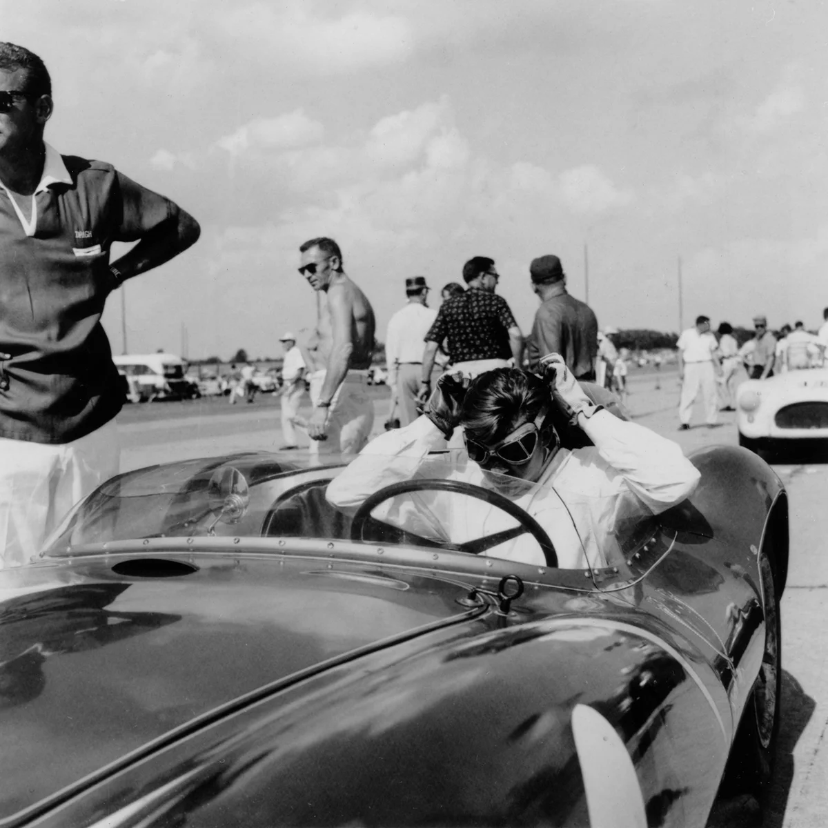 Lance Reventlow gets ready to race. Pretty sure that is Phil Remington standing next to him.
