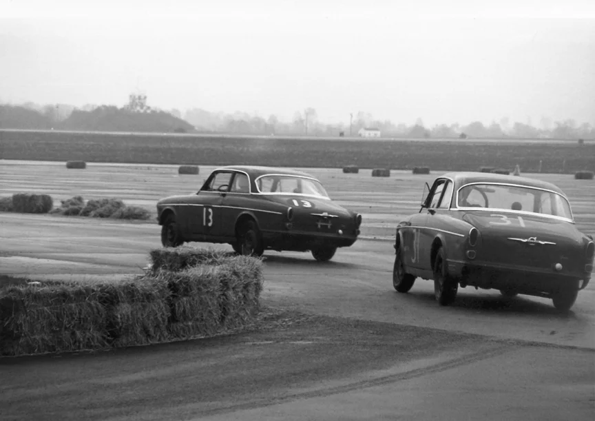 Reading in 1962 was one of the first race meets to allow sedans. A pair of Volvo's slide onto the runway.