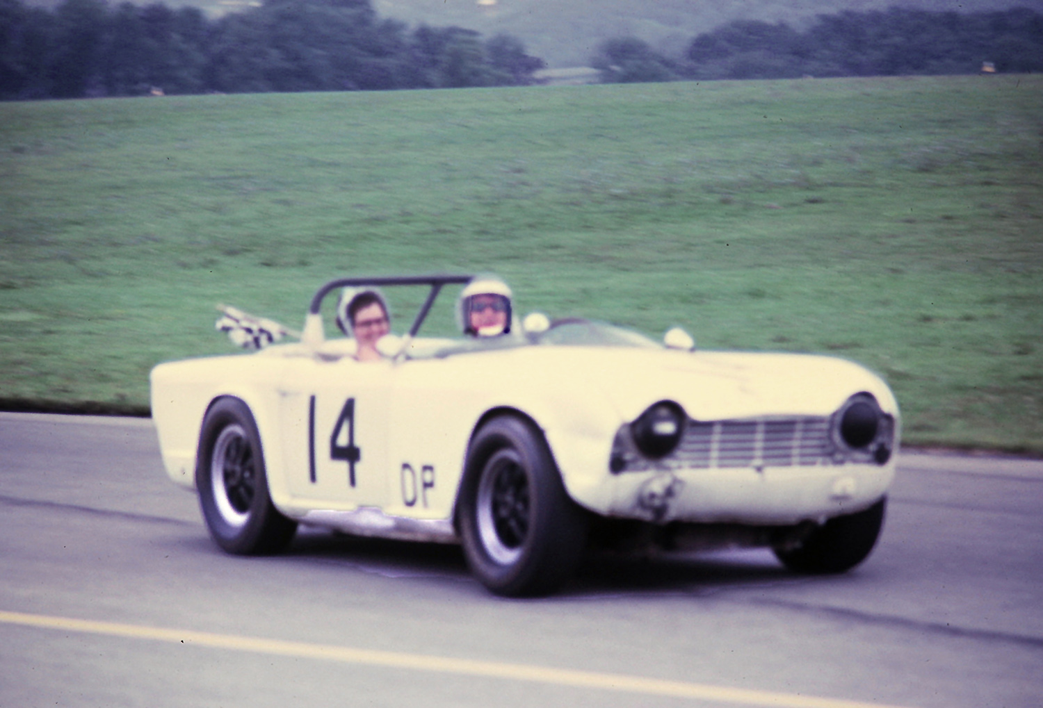 Keith Kendig celebrates his victory in DP in the #14 Triumph TR-4.